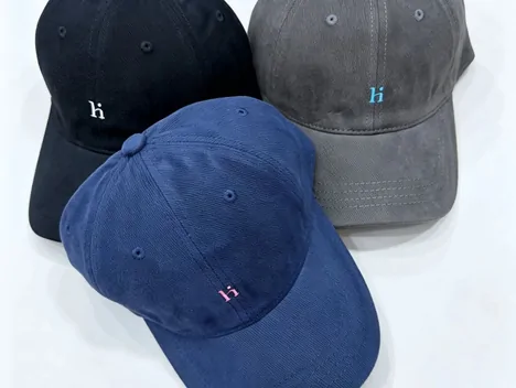 Three washed baseball caps in navy, black and grey with small embroidered initials